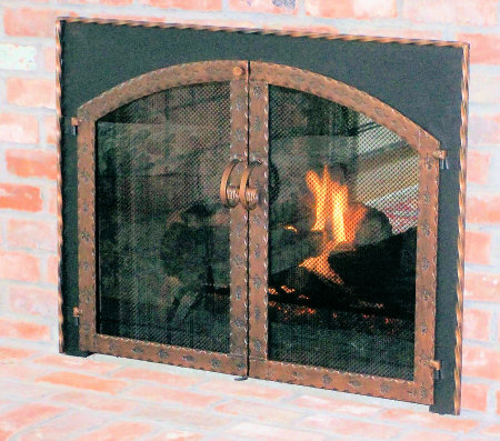 The Hyannisport Square to Arch Black frame with antique copper twisted molding, scrolled grape steel twin doors, with standard forged center handles,  smoke glass. Comes with slide mesh spark screen